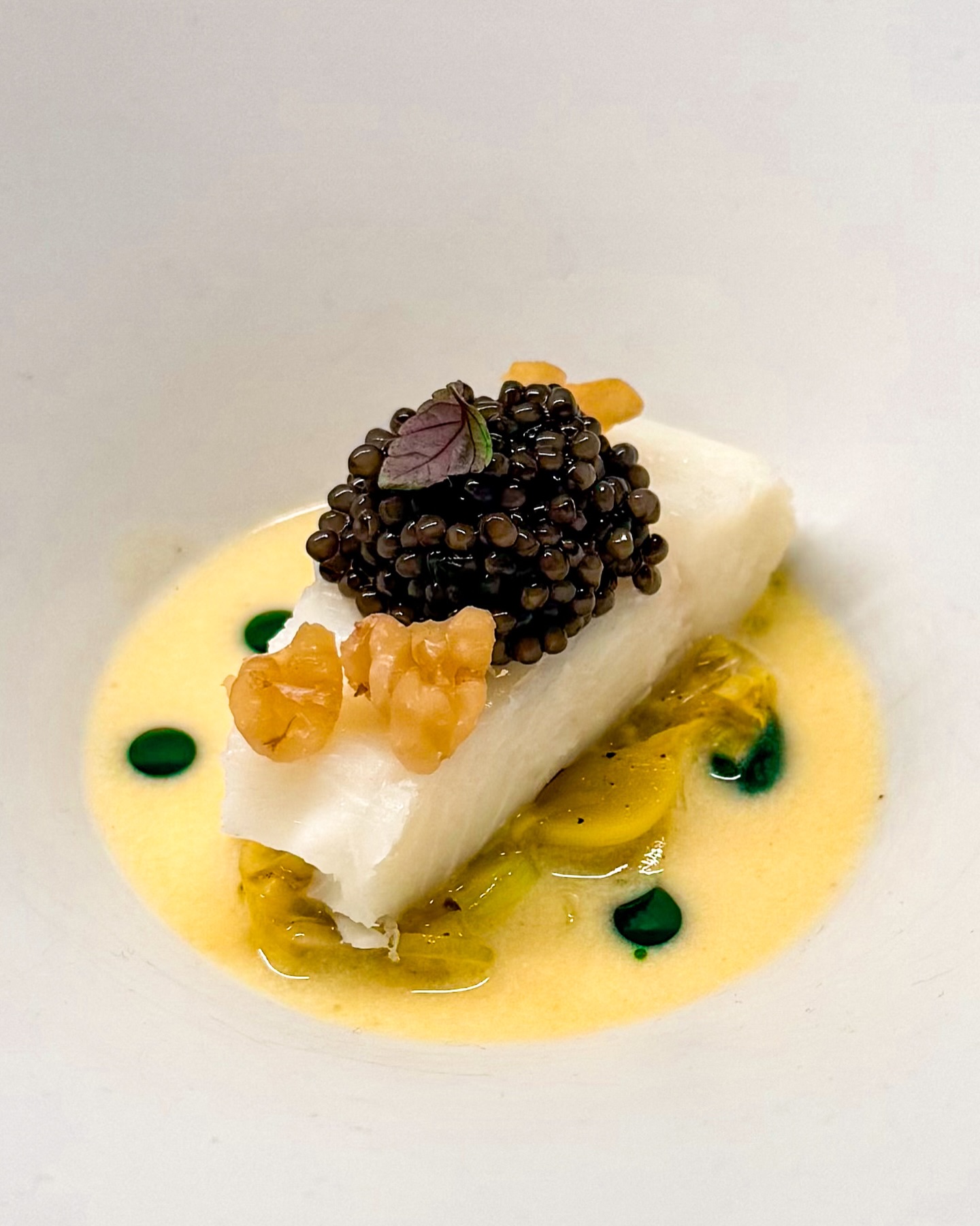 🐟🌿 Heilbot • Prei • Witte asperge
🇬🇧🐟 Halibut • Leek • White asparagus 

Soms werken ingrediënten gewoon heel goed samen, versterken ze elkaar en kunnen ze verrassen. Dat is hier allemaal aan de hand 👨🏼‍🍳 

Je ziet gestoofde prei met hierop gepocheerde heilbot. Erop een lekker wat kaviaar en stukjes ontvelde walnoot 🌰 

De saus is een frisse en romige beurre blanc op basis van gefermenteerde witte asperges. Wat druppels kruidenolie maken het compleet 🌿 

✌️